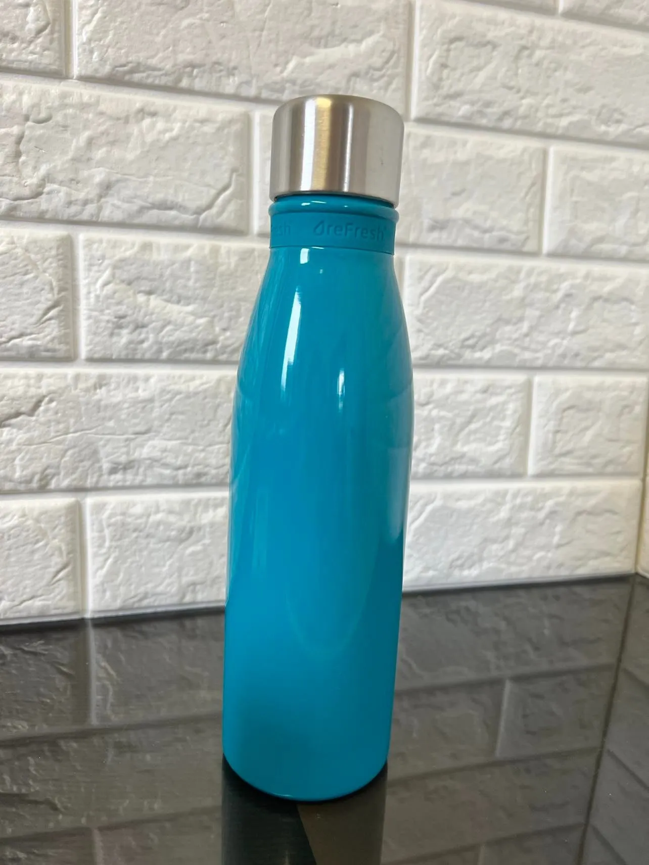 Refresh Mayon Vacuum Insulated  double wall stainless Bottle - 18 oz. Keeps beverages hot or cold for hours. Complete with a Refresh silicone band on the bottle's neck.